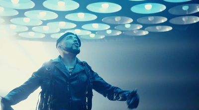 a man standing in front of a ceiling of lights