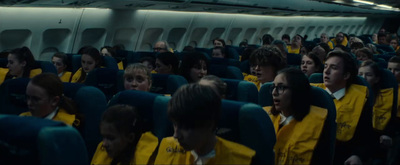 a large group of people sitting on an airplane