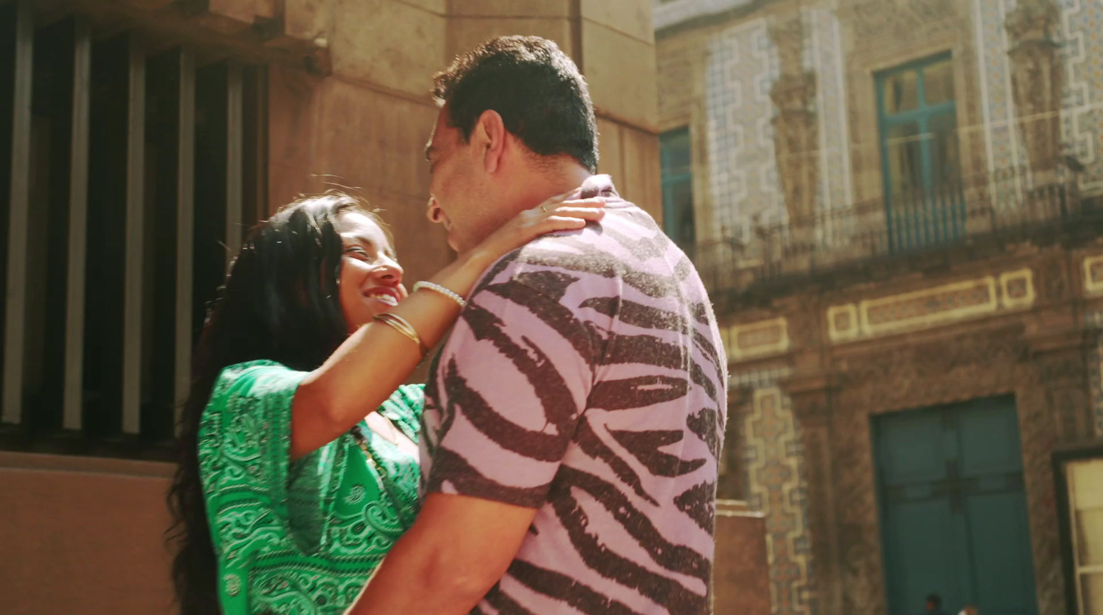 a man and a woman standing in front of a building