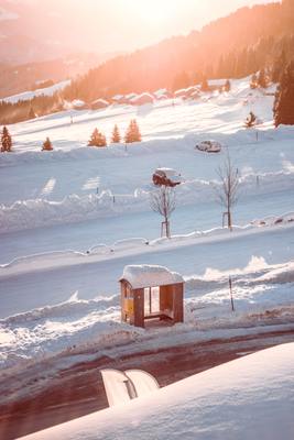 a small building in the middle of a snowy field