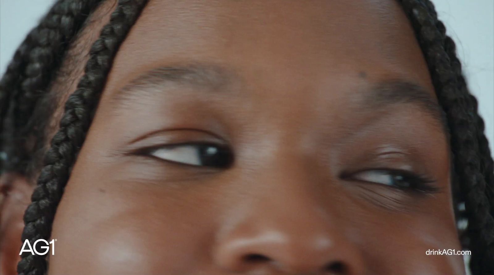 a close up of a person with braids on her head