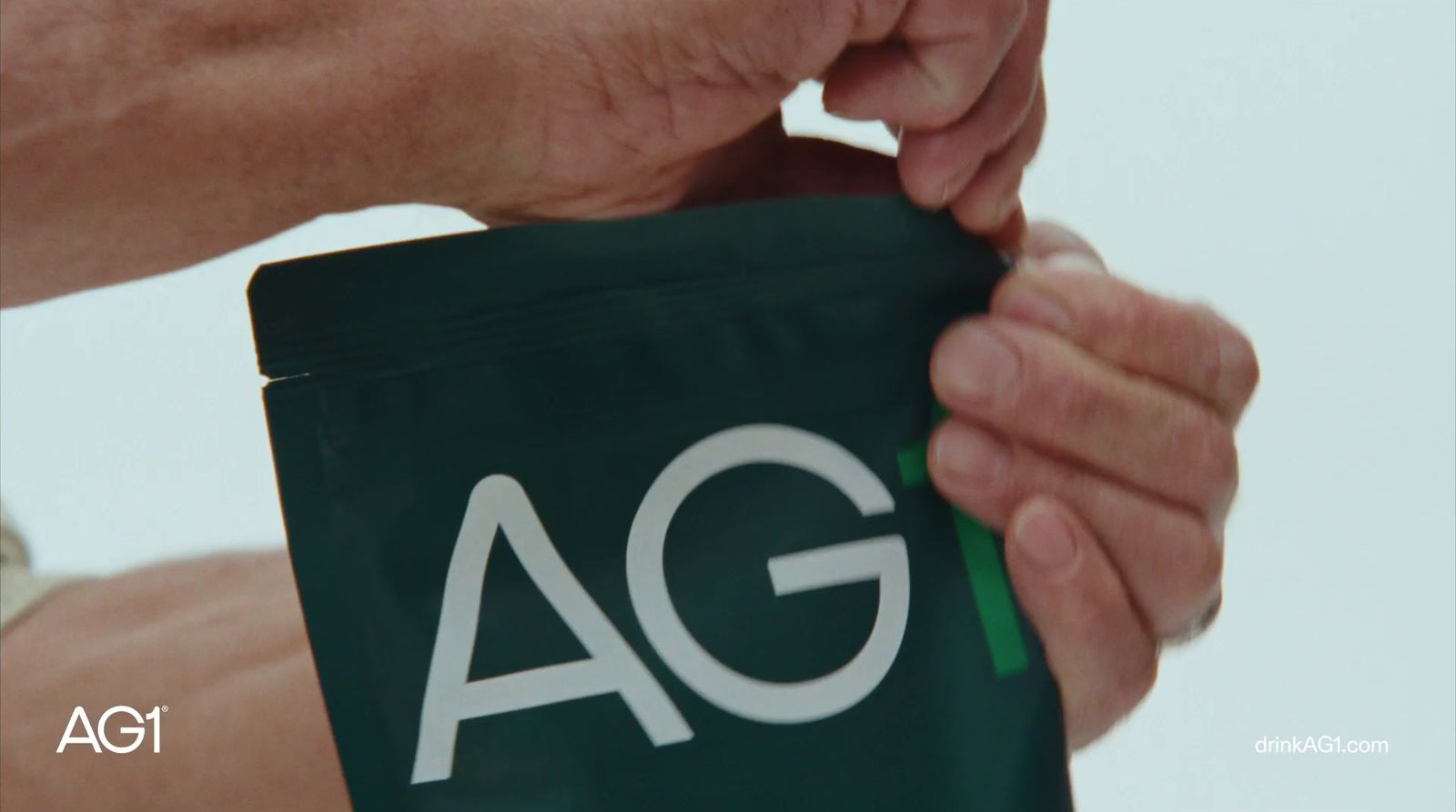 a person holding a bag with the word ag on it