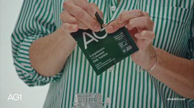 a woman holding a business card in her hands