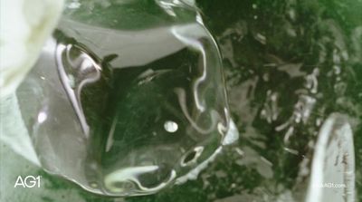 a close up of a green glass vase