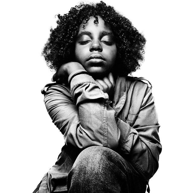 a black and white photo of a woman with curly hair