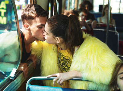 a man and a woman kissing on a bus