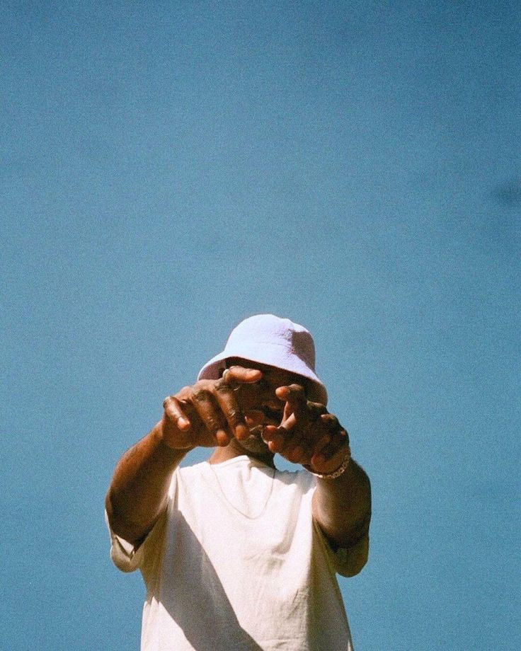 a man in a white shirt and a white hat