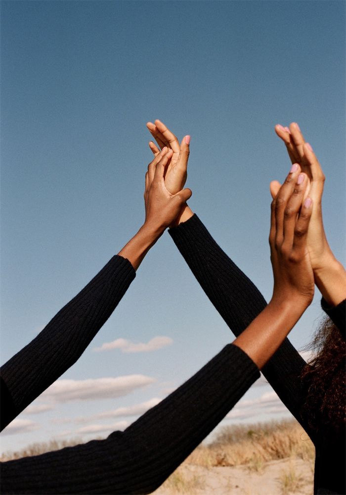 a group of people holding their hands together