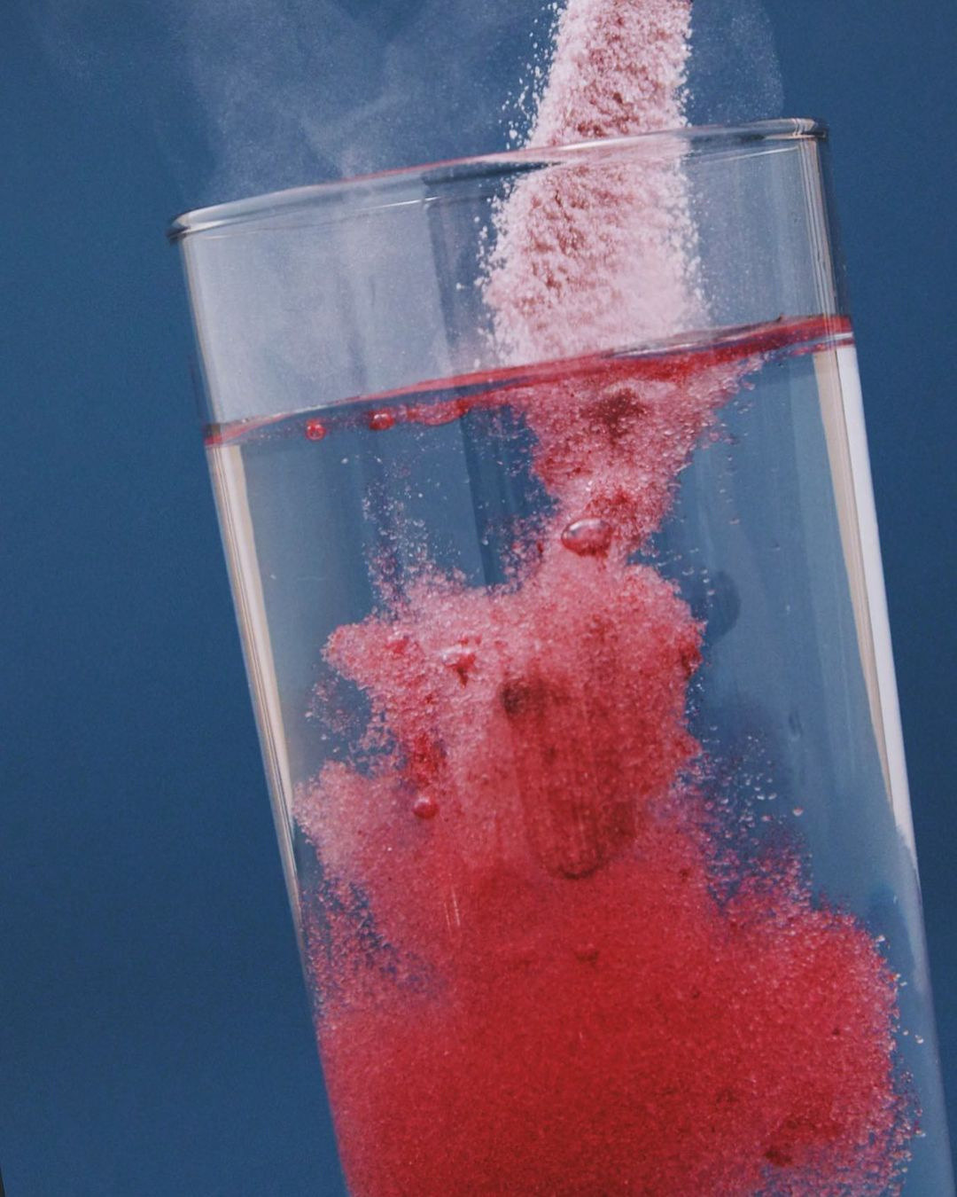 a red substance in a glass of water