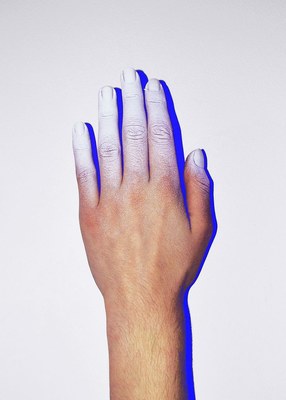 a person's hand with white and blue nail polish