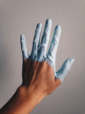 a person's hand covered in blue paint