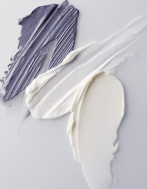 a close up of a paint brush and a white paint