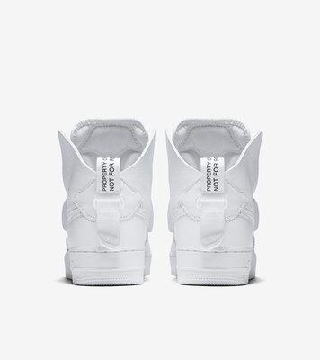 a pair of white sneakers on a white background