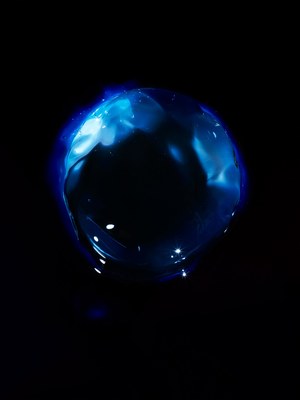 a blue glass object sitting on top of a table