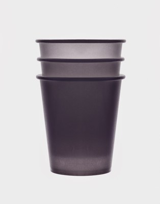 a purple cup sitting on top of a white table