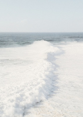 a man riding a surfboard on top of a wave in the ocean