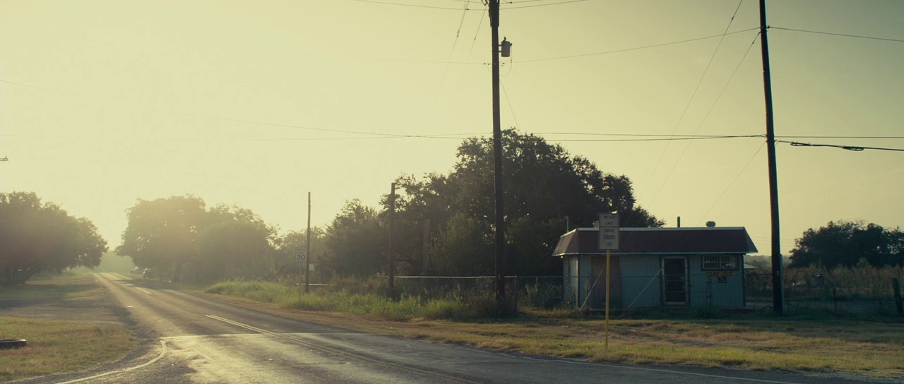 a small house sitting on the side of a road