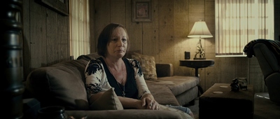 a woman sitting on a couch in a living room