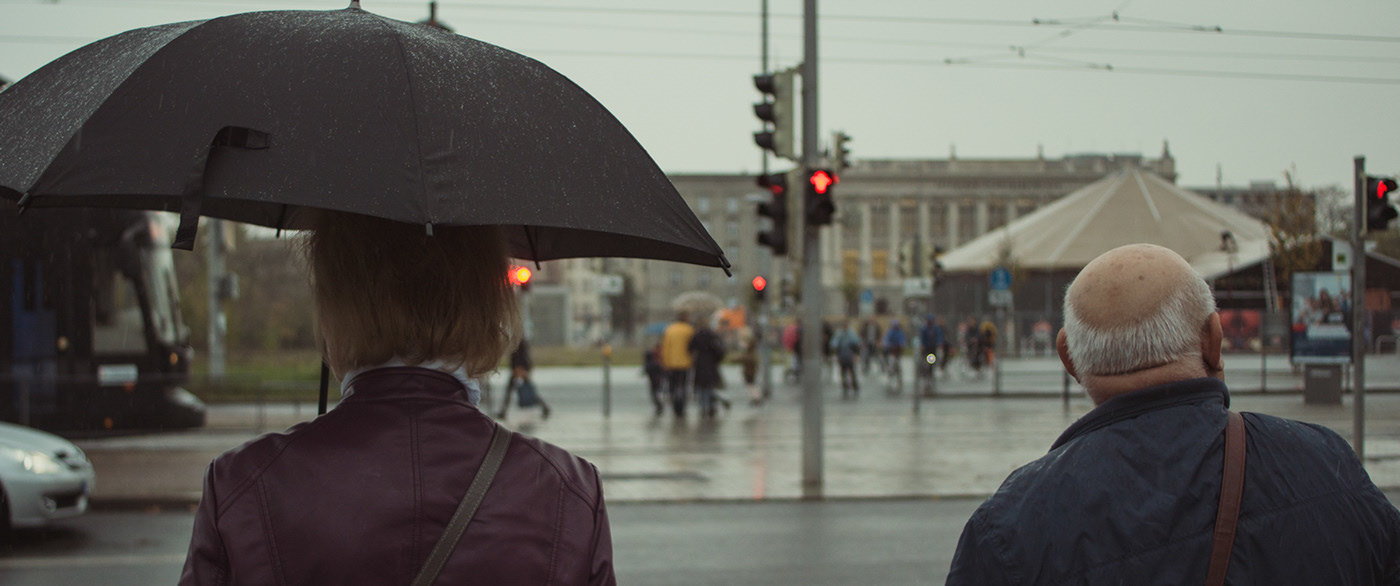 a couple of people that are standing under an umbrella