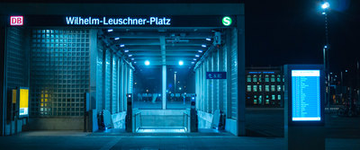 the entrance to a subway station at night