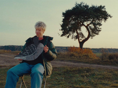 a woman sitting on a chair holding a kite