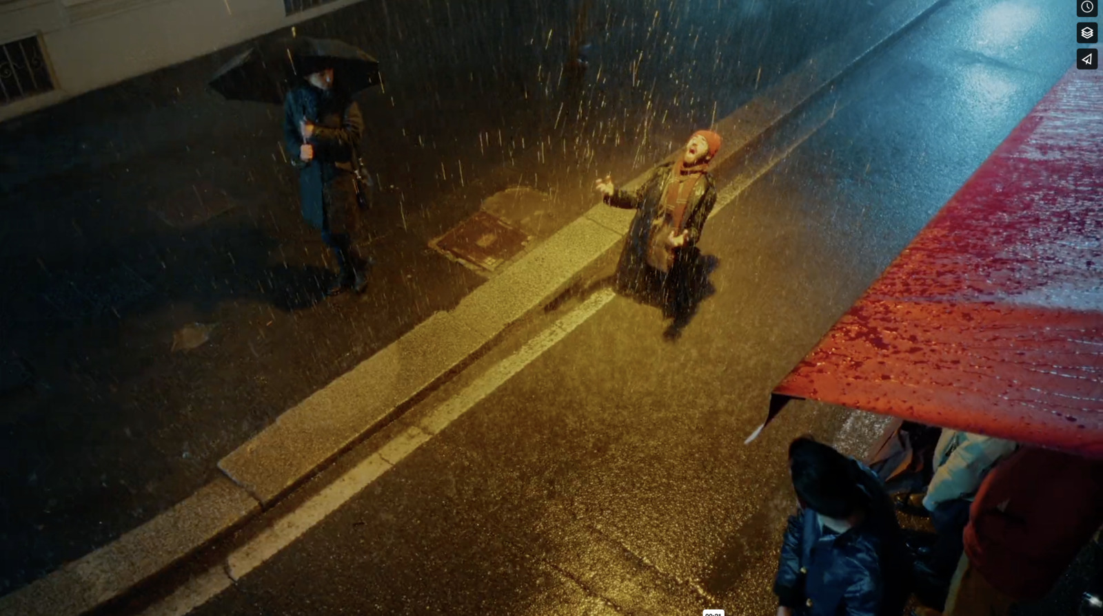 a couple of people walking down a street in the rain