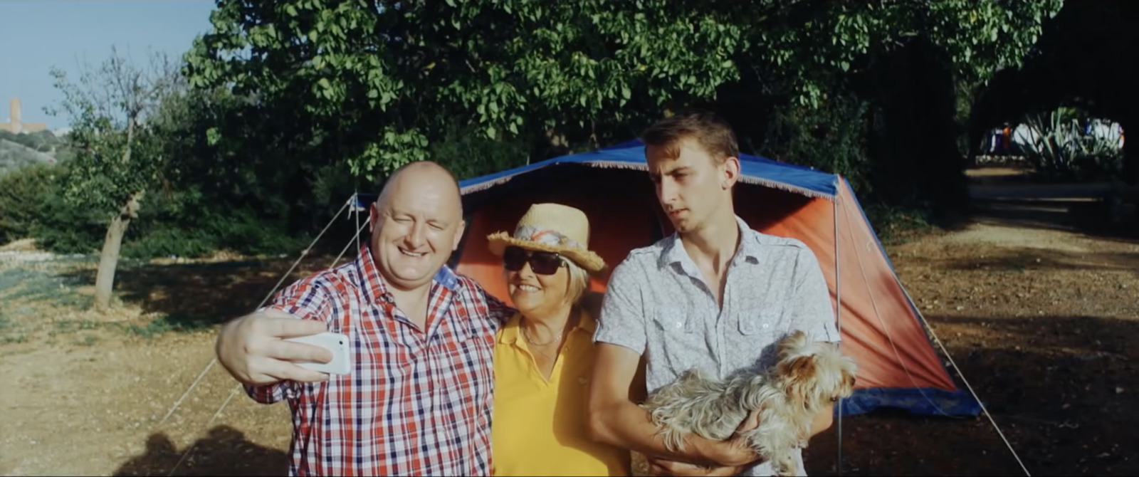 a couple of men standing next to a tent