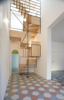 a spiral staircase in a house with a tiled floor