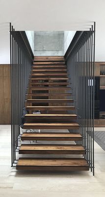 a set of wooden stairs with metal railings