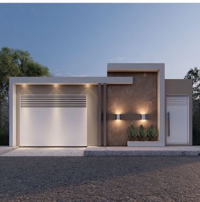 a modern house with two garages and lights