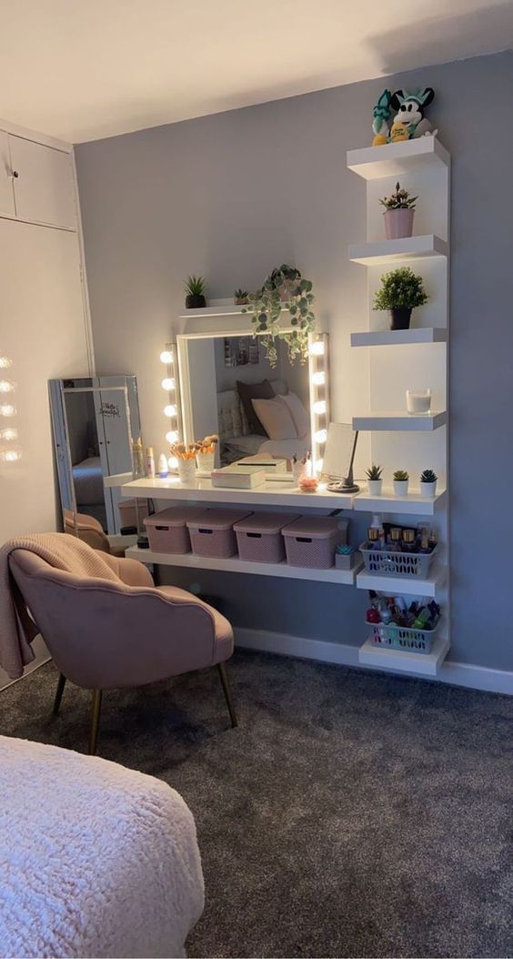 a bedroom with a bed, chair, mirror and lights