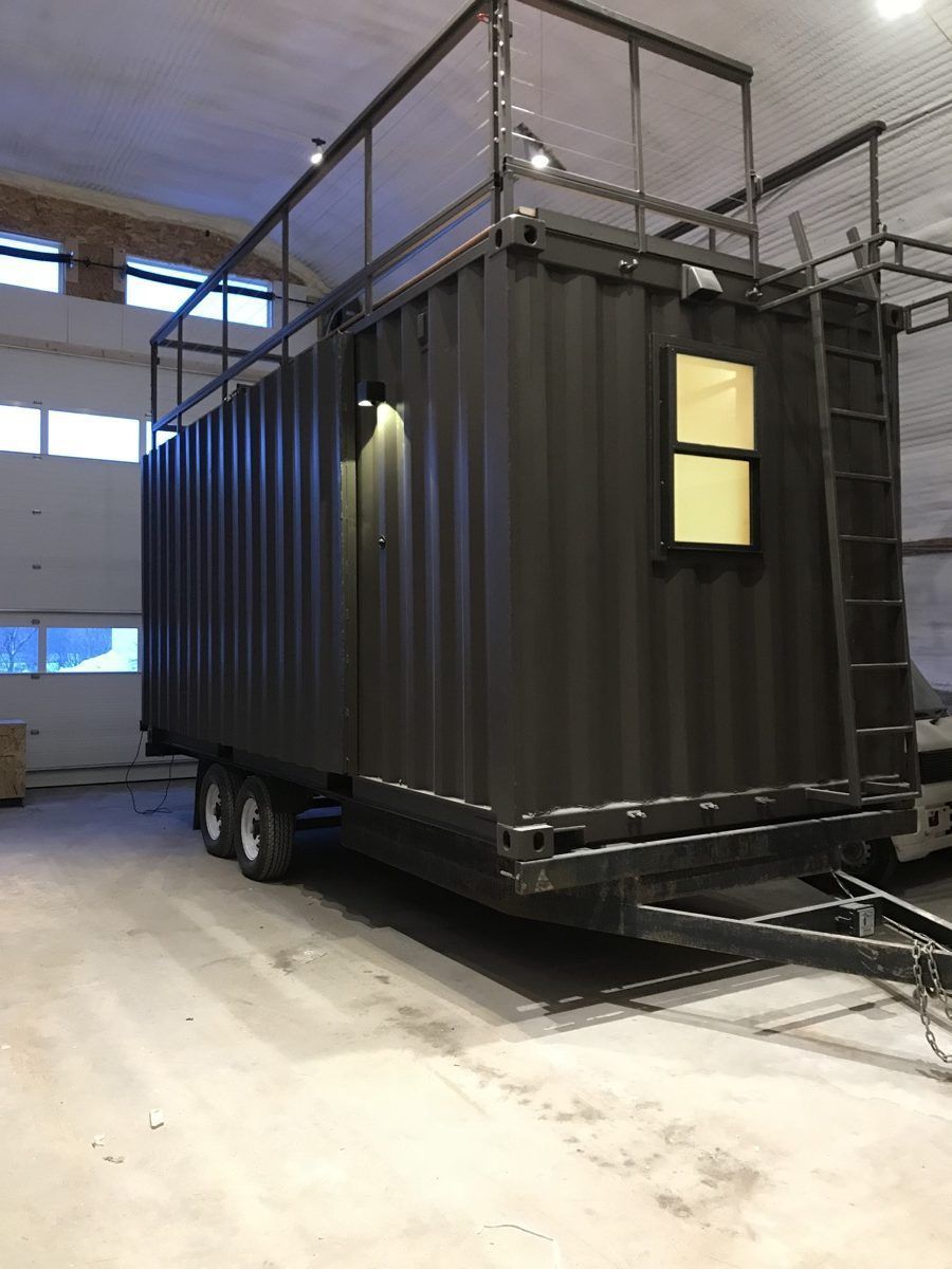 a large black container sitting inside of a warehouse