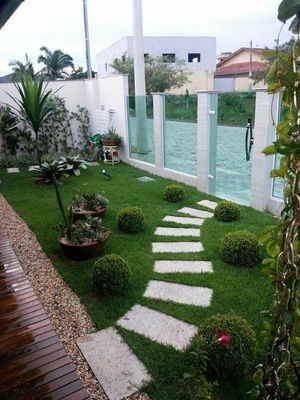 a small garden with stepping stones in the grass