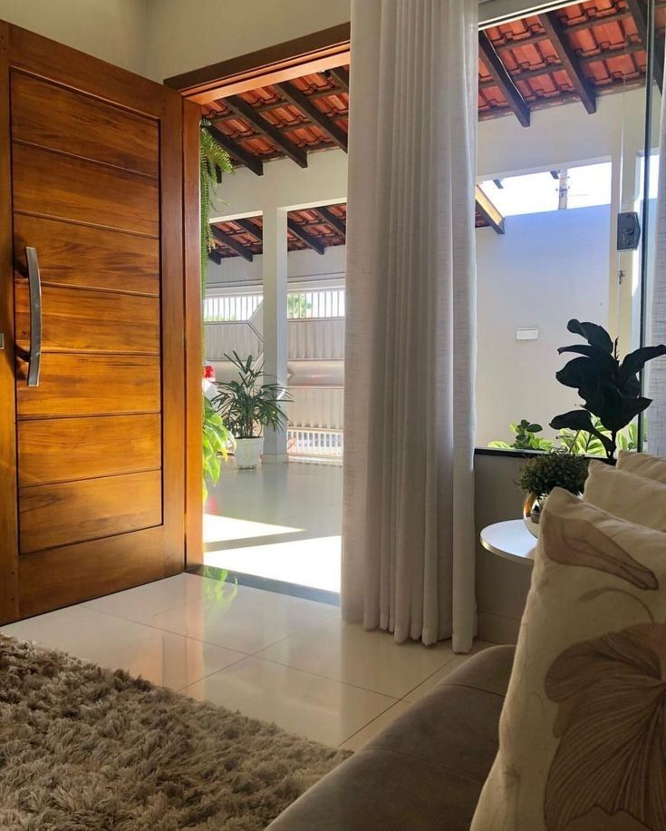 a living room with a couch and a wooden door