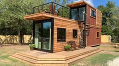 a small wooden house with a balcony and stairs