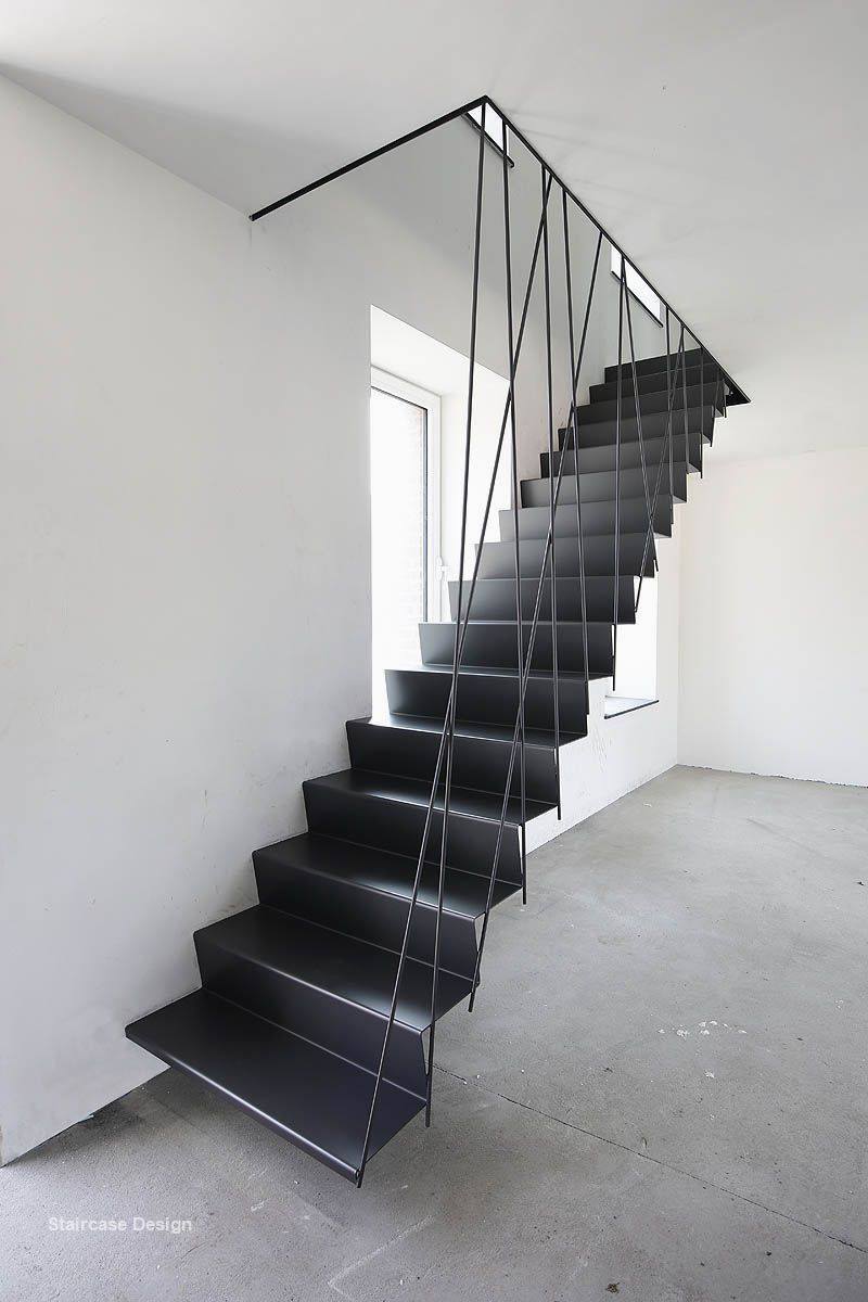 a set of black stairs in a white room