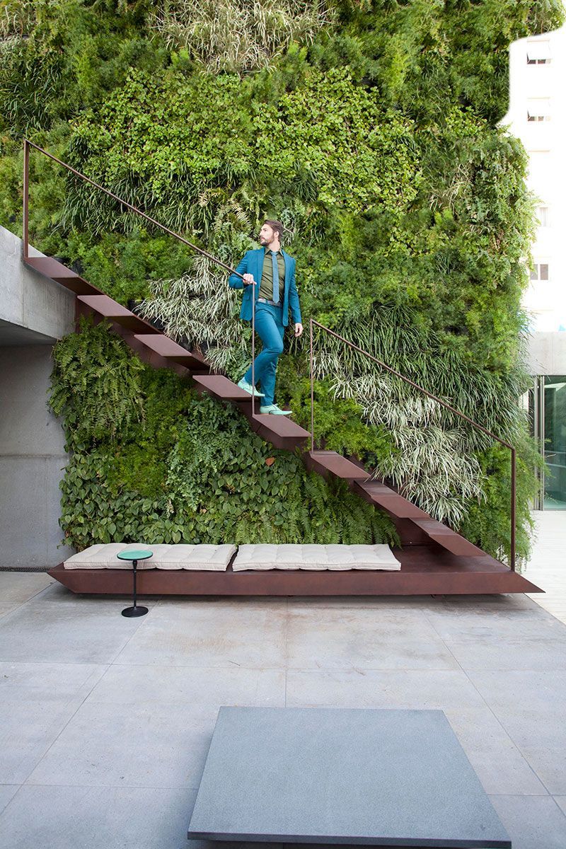 a man in a suit climbing up a set of stairs