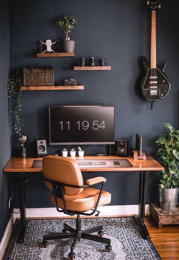 a home office with a guitar on the wall