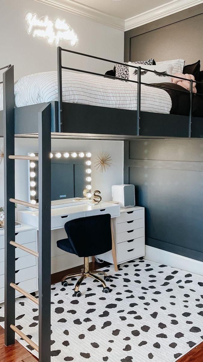 a loft bed with a desk underneath it