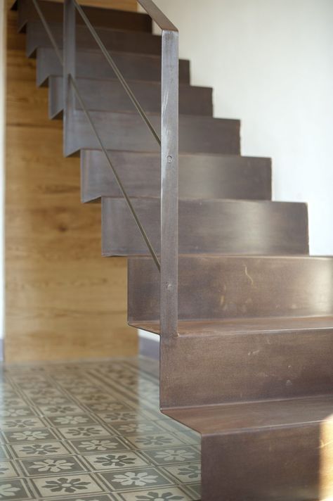 a close up of a set of stairs on a tiled floor