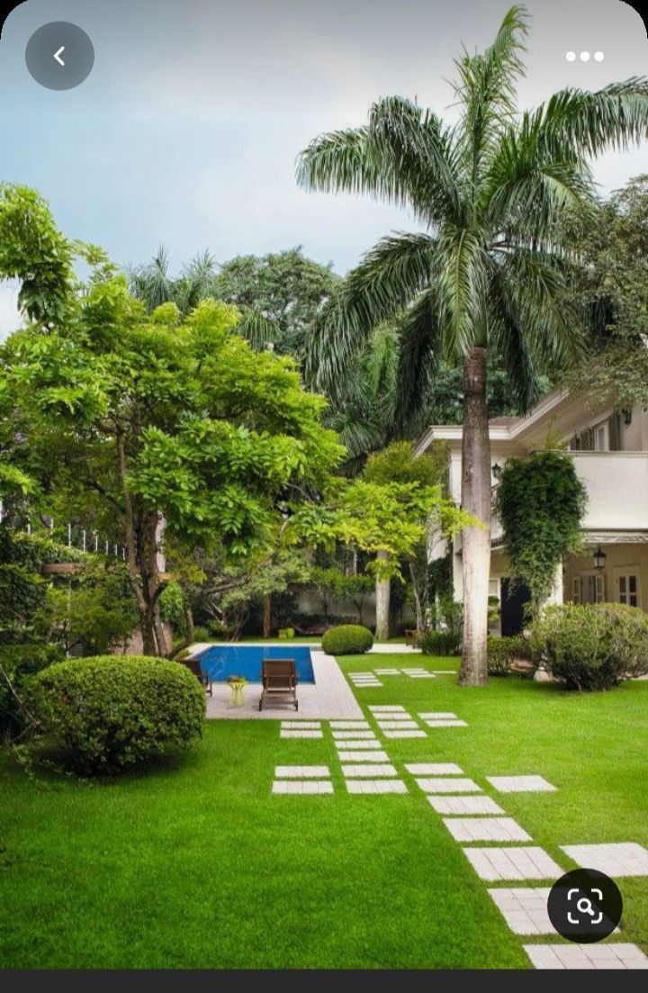 a house with a pool in the middle of the yard