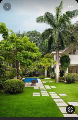 a house with a pool in the middle of the yard