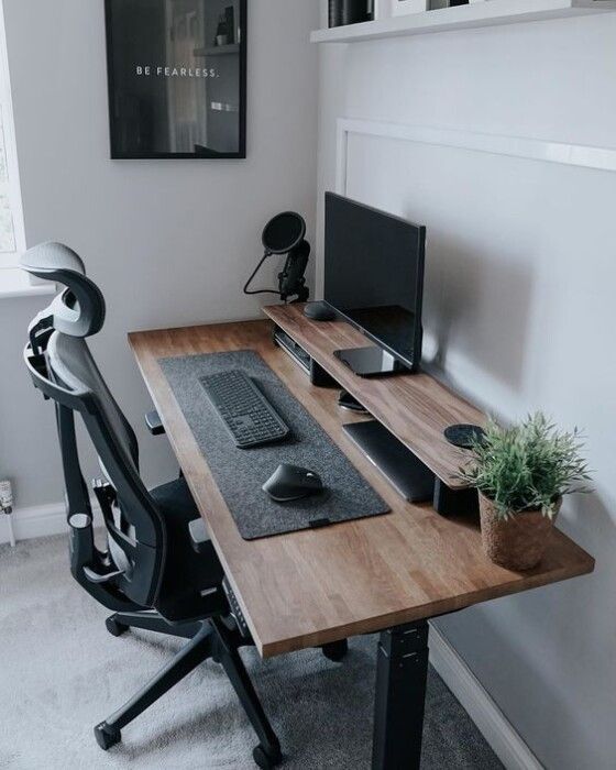 a desk with a monitor, keyboard and mouse on it