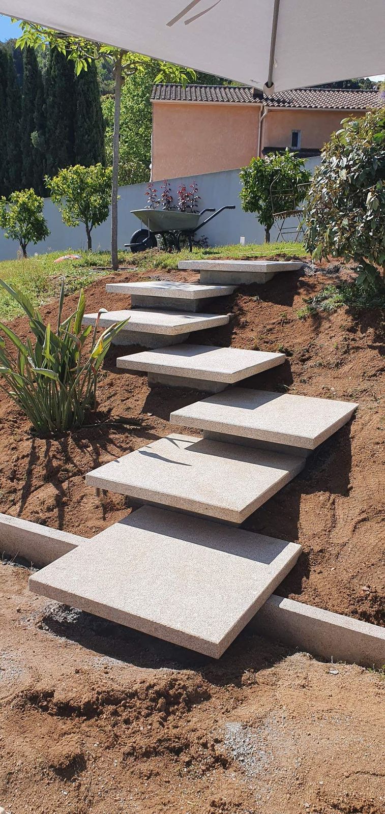 a set of concrete steps sitting in the dirt