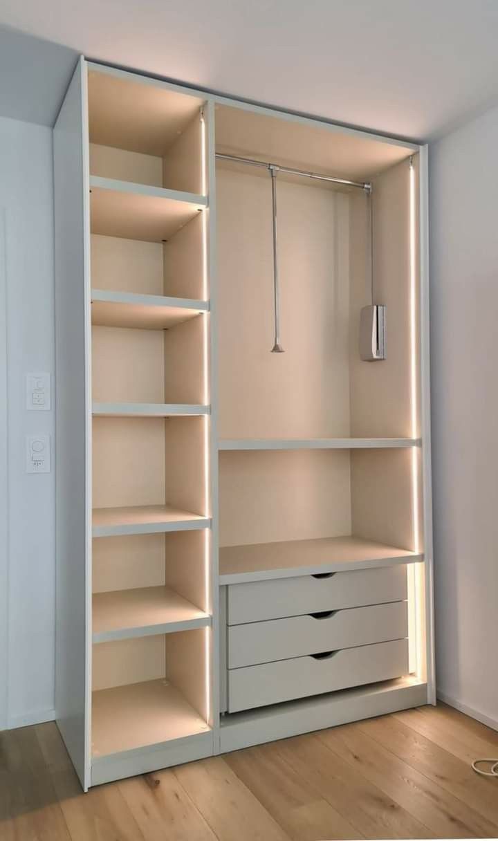 a white closet with drawers and a hanging light