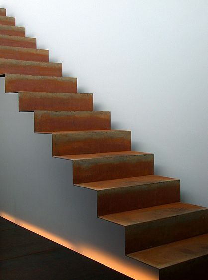 a set of stairs leading up to a white wall