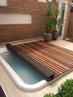 a hot tub sitting on top of a wooden deck