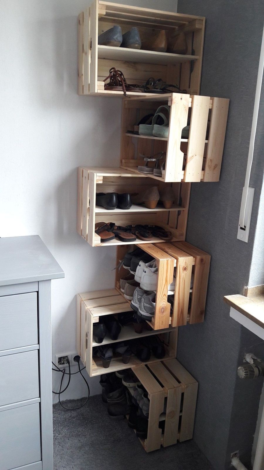 a room with a lot of wooden shelves and shoes