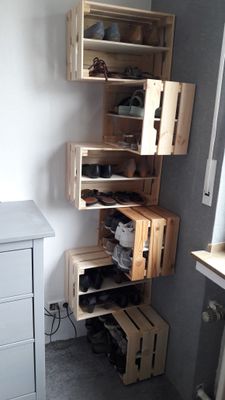 a room with a lot of wooden shelves and shoes