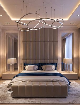 a bedroom with a large bed and a chandelier